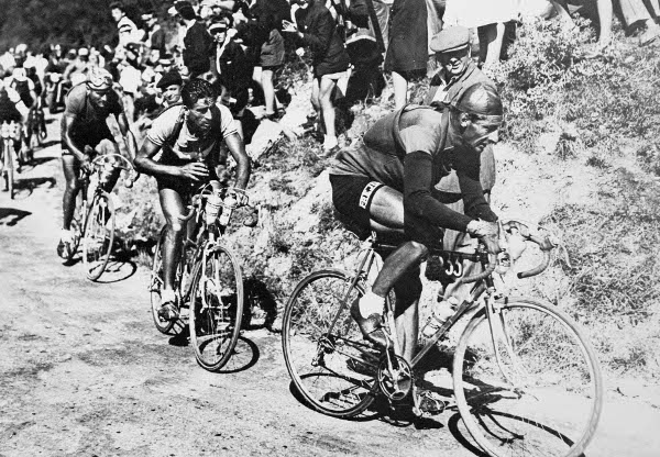 Ferdinand Kübler rides in front of Raphaël Géminiani on Col de la République during Stage 19 of the 1950 Tour de France. Provide a caption below for a chance to win. Photo credit: Miroir Archives/PhotoSport International