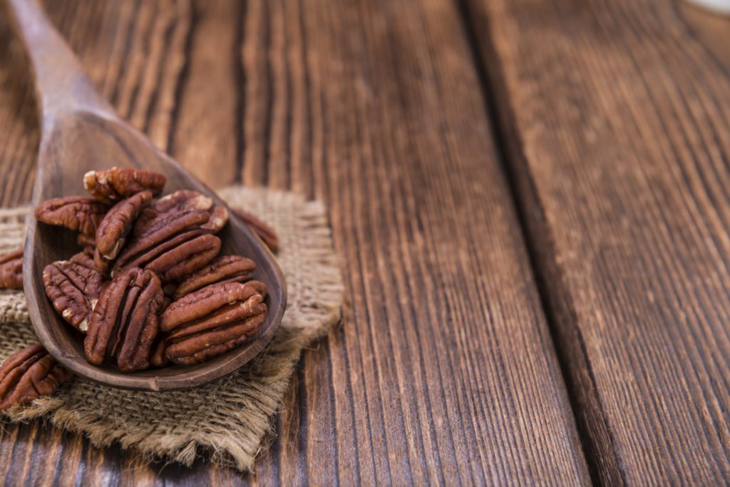 Pecan Nuts (selective focus) on an old vintage wooden table