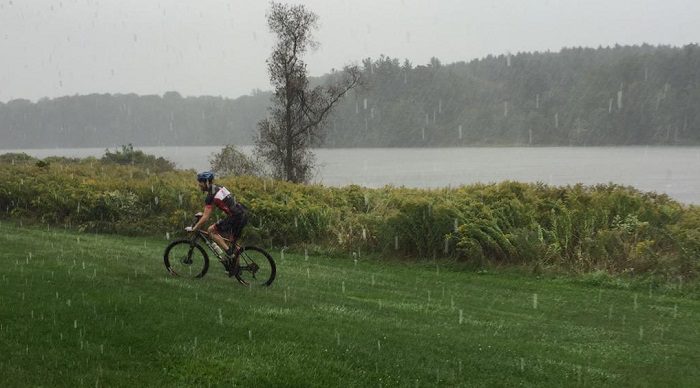 A rider checks out the course of the Dirt Squirrel Cyclocross in the rain near Christie Lake, the day before competition. (Image credit: Slow burn racing/Twitter)