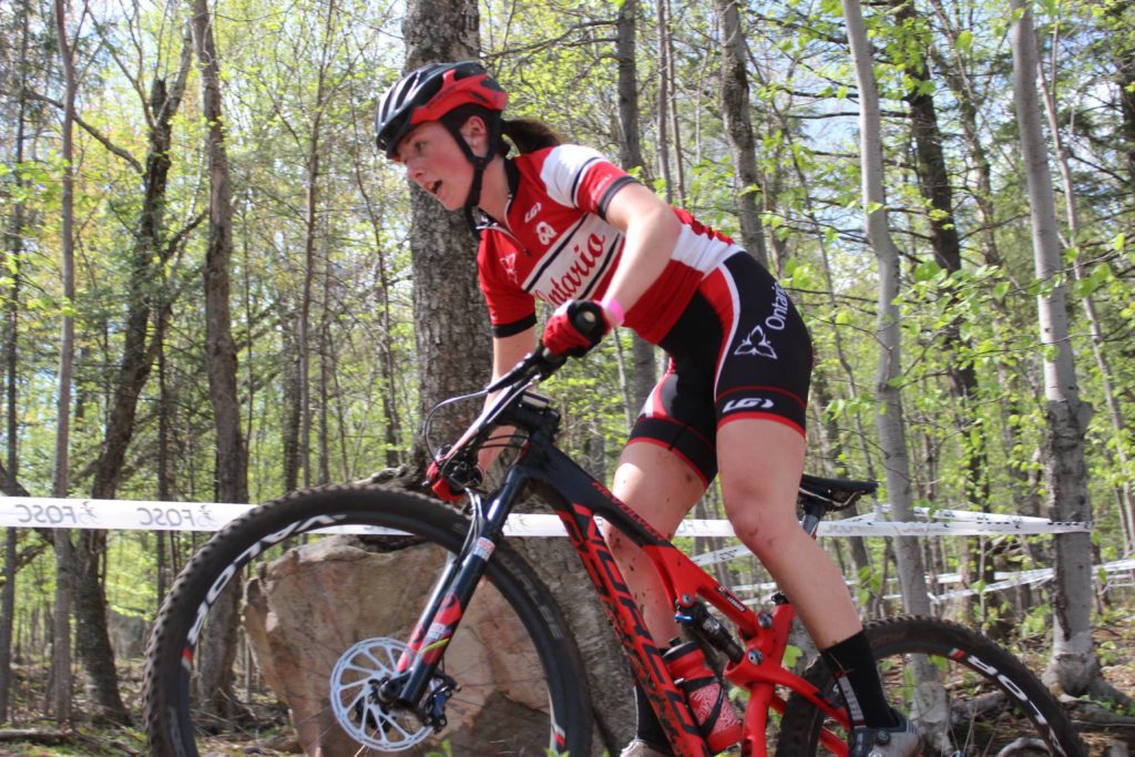 Erica Leonard riding over rocks at Tremblant. Photo credit: Peter Glassford