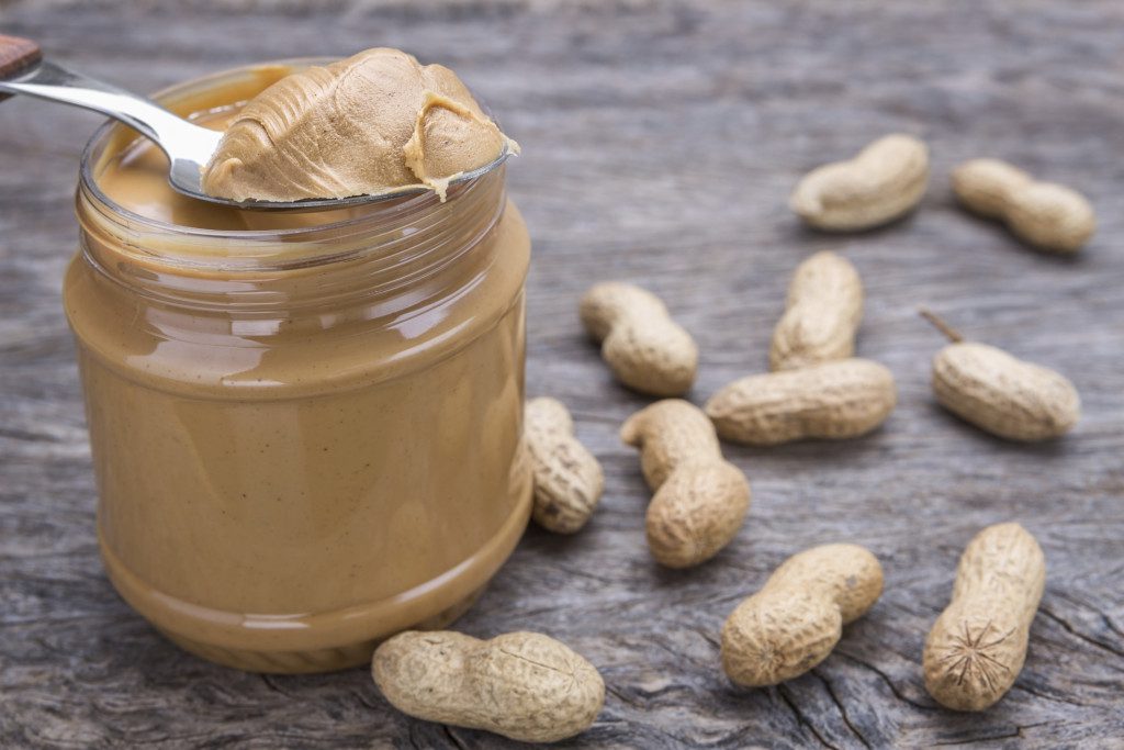 Jar of peanut butter with nuts.