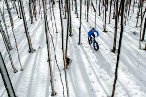 Fat biker riding his bicycle in the snow during Canadian winter
