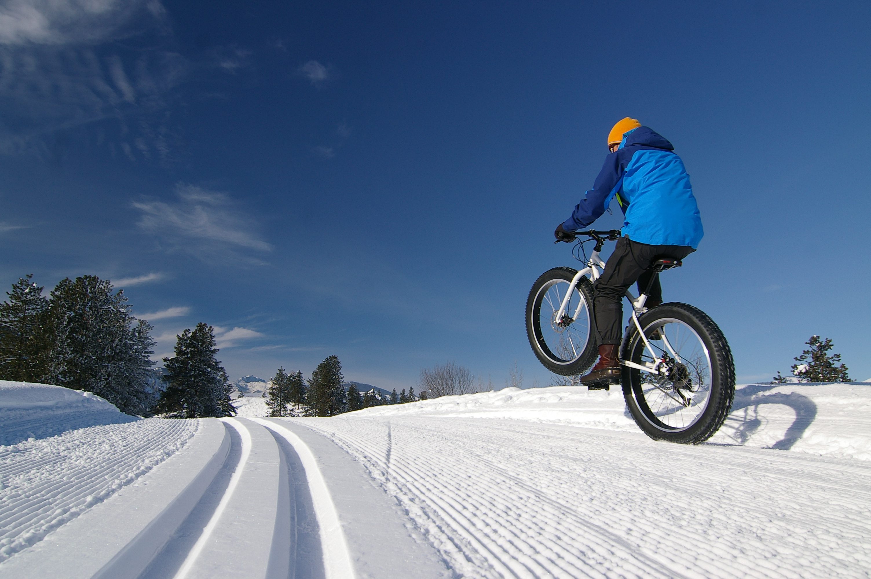 Biking in the snow is super fun on a fat bike. The tires are wide enough so that traction is great, and the tires do not sink into the packed snow of the cross country ski trail.
