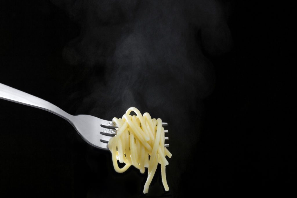 Hot spaghetti on black background