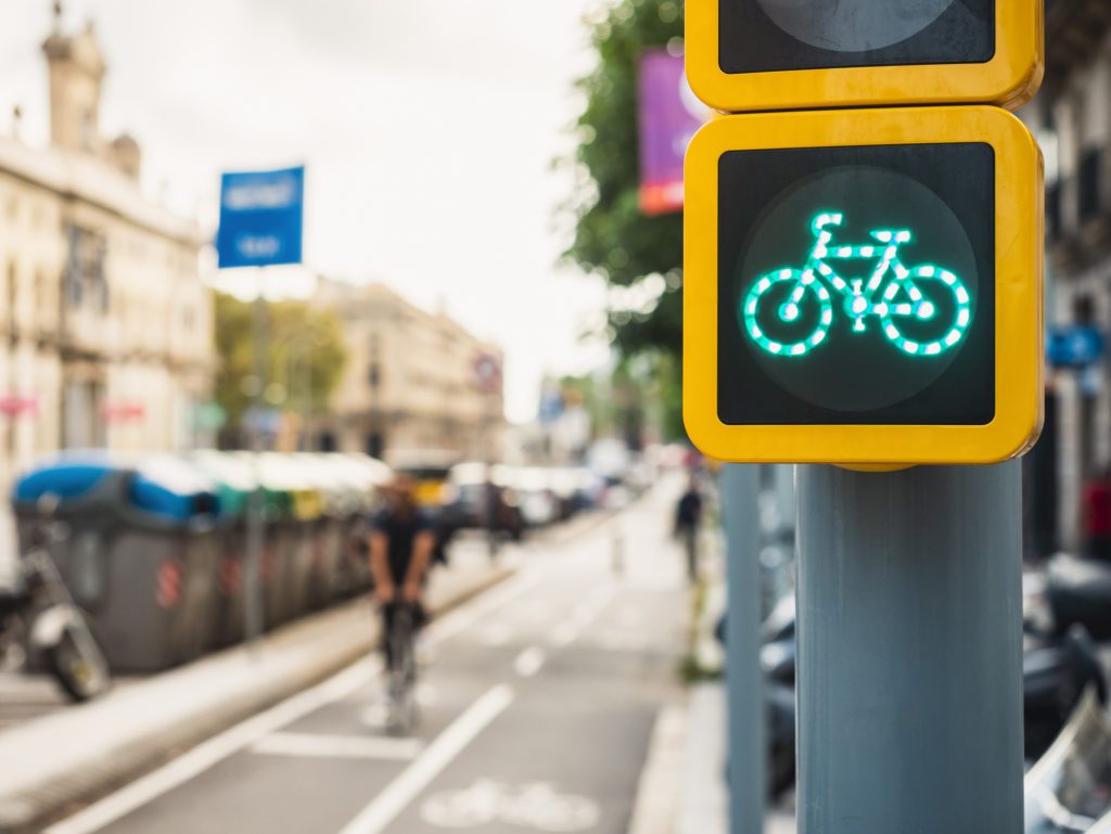 Bicycle Sign Traffic Light City Street People riding on Bike lane Ecology lifestyle Transportation