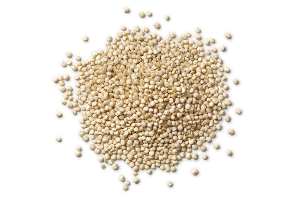 Heap of raw Quinoa seeds on white background