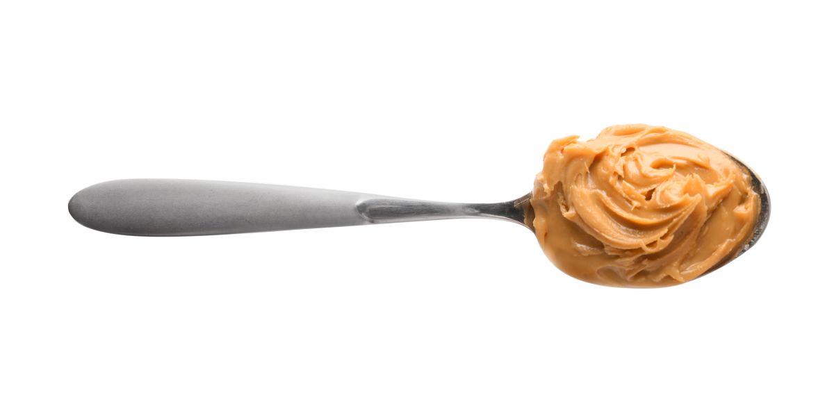 Creamy peanut butter in spoon on white background - Canadian Cycling  Magazine