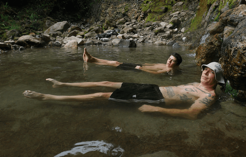 Rob Warner and Finn Iles relax in a hot spring in Colombia 