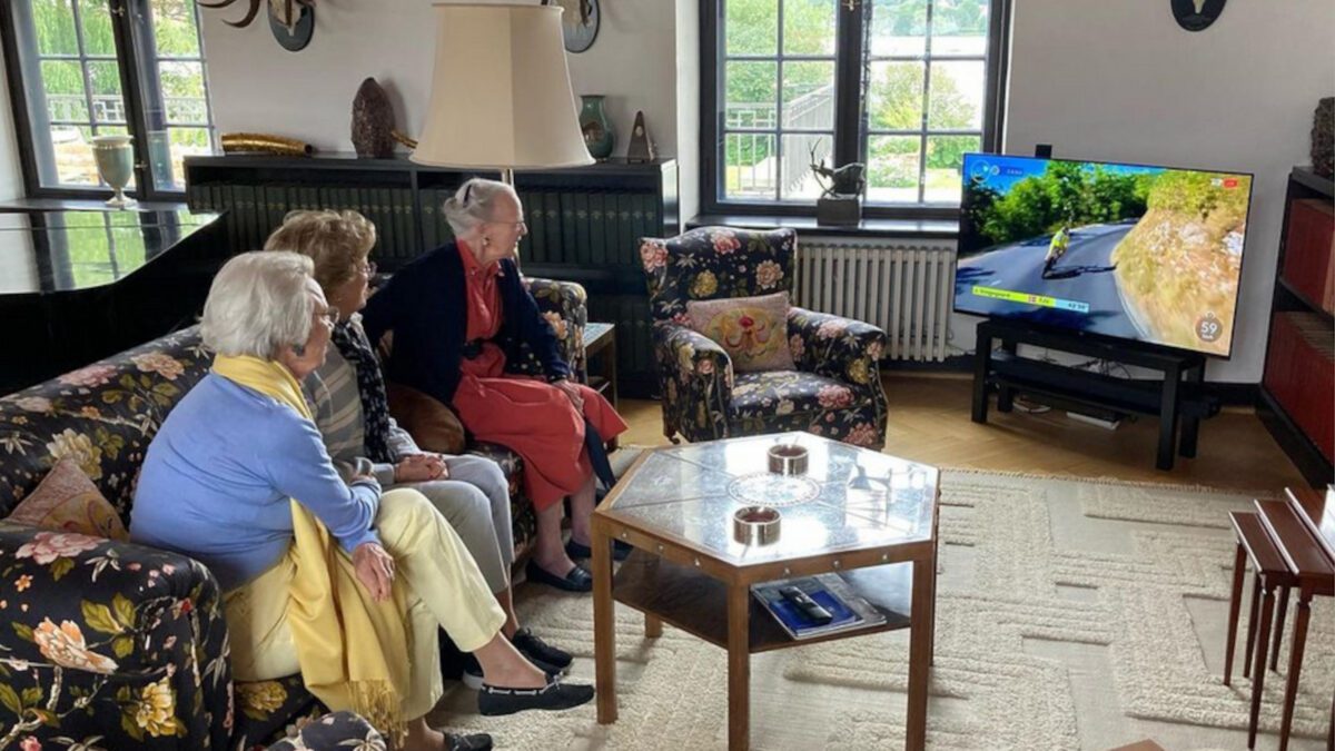 Queen Margrethe sitting on a couch watching television