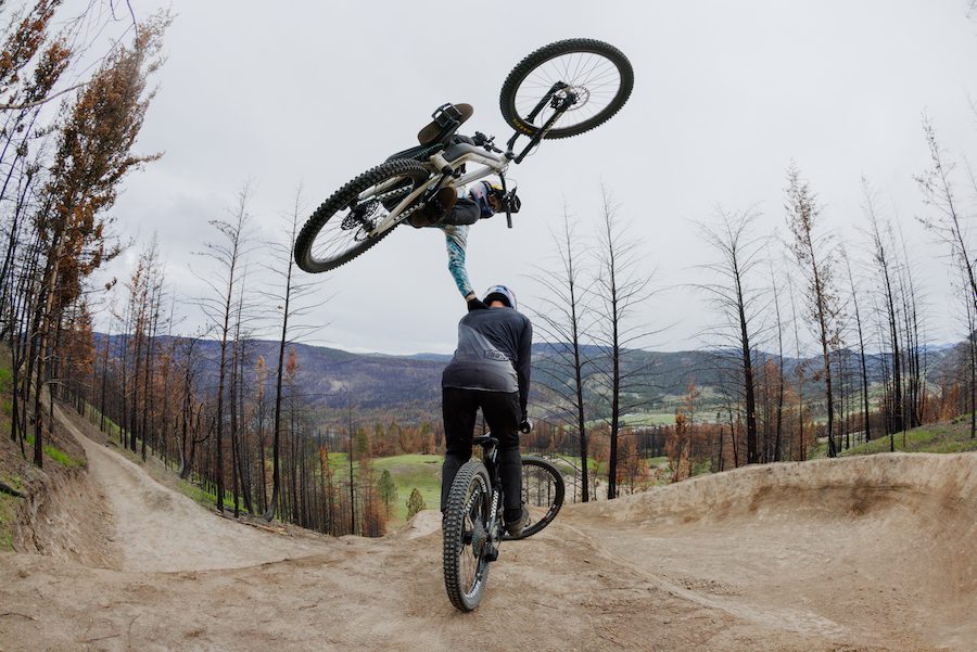 One mountain biker jumps over another
