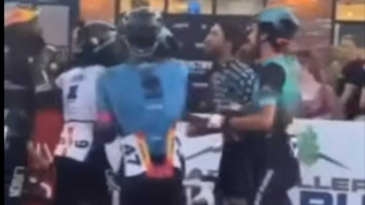 cyclists are in a fist fight at the Salt Lake Criterium