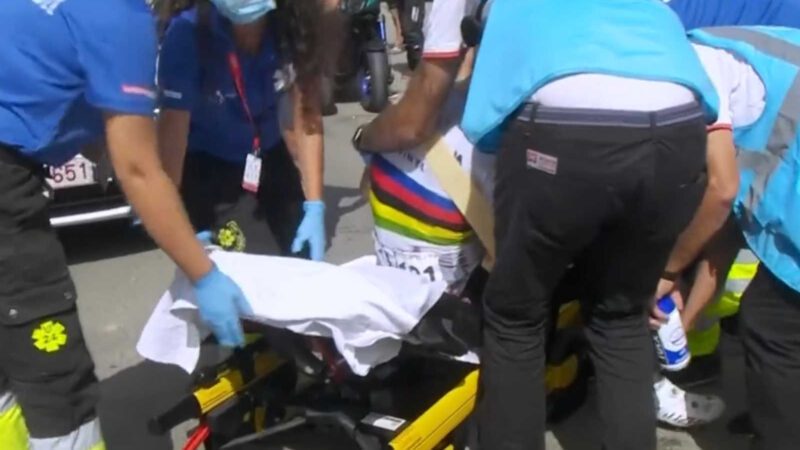 Julian Alaphillipe on a gurney being taken care of by paramedics