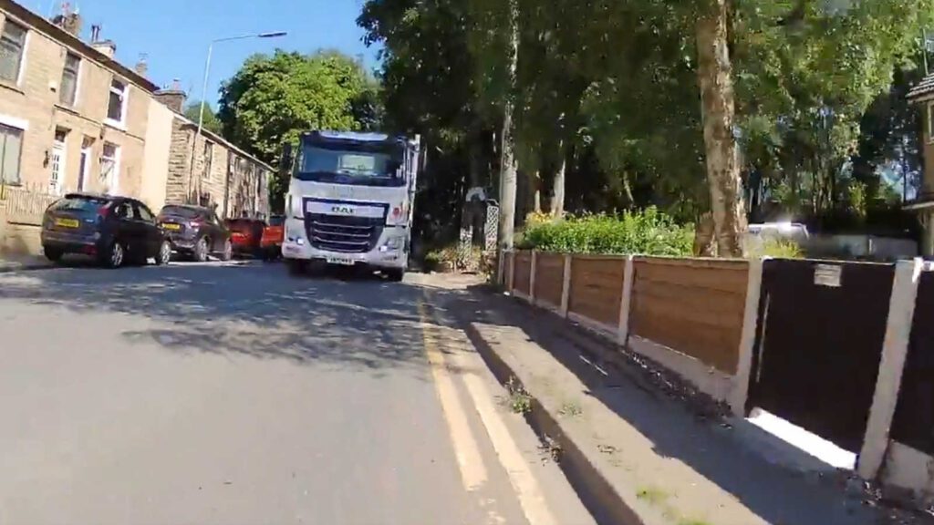 A truck passing a cyclist