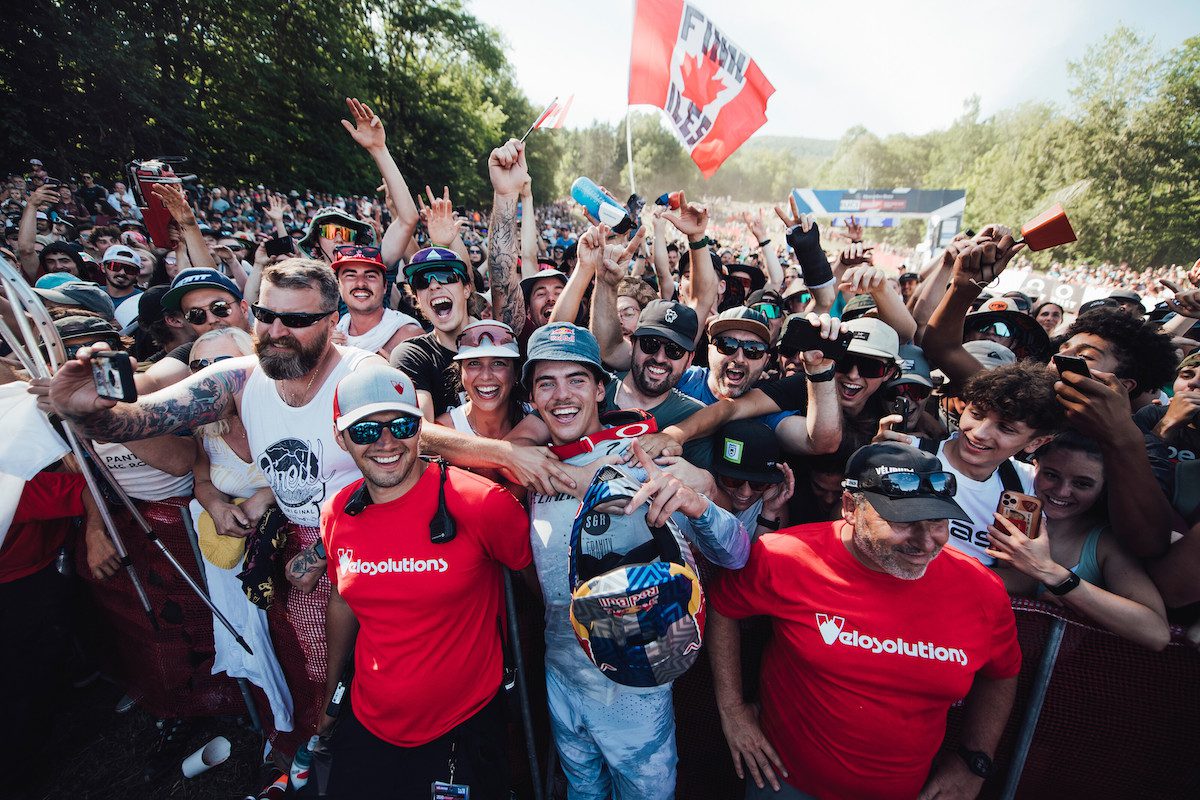 Finn Iles celebrates winning the 2022 Mont-Sainte-Anne World Cup with a throng of Canadian fans 