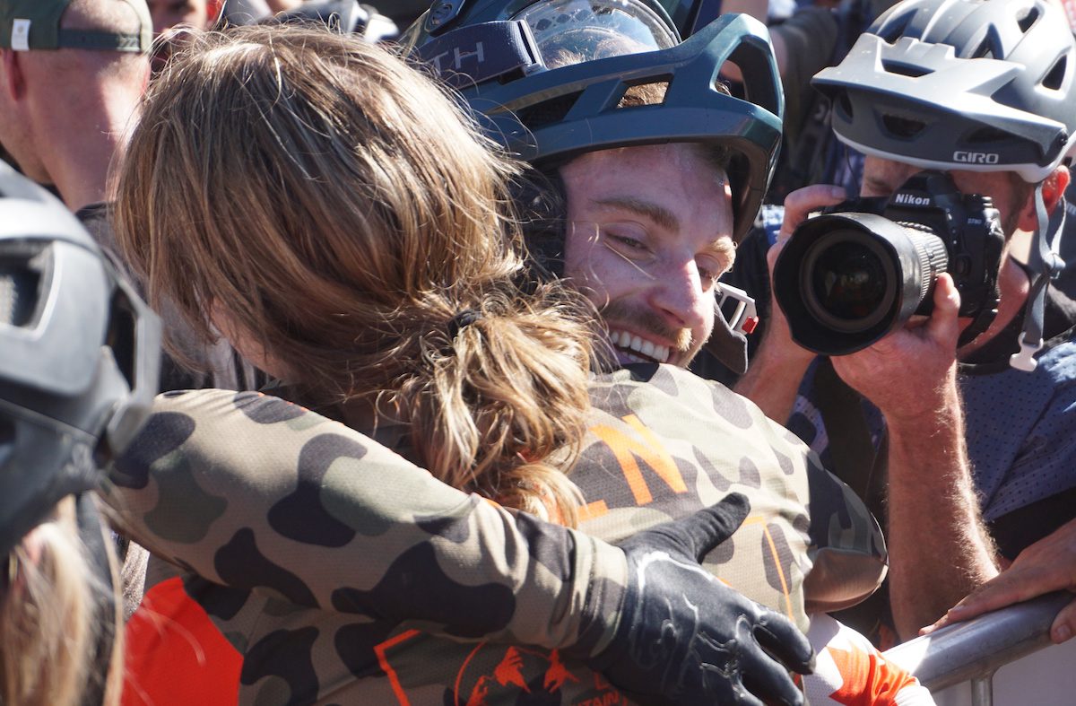 Andréane Lanthier Nadeau and Jesse Melamed hug at finish line of EWS Whistler 
