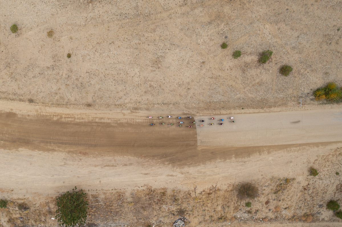 Arial photo of a riders crossing from pavement to gravel roads in the Okanagan