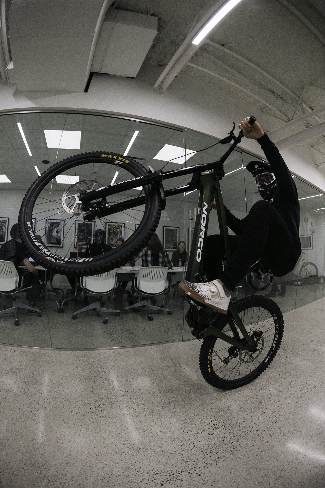 Mark Wallace rides his Norco Factory Team downhill bike inside the Norco office 