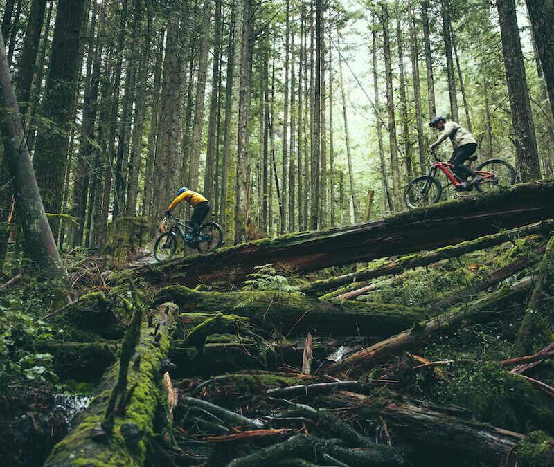 Wade Simmons and Steve Vanderhoek ride a log on vancouver's north shore
