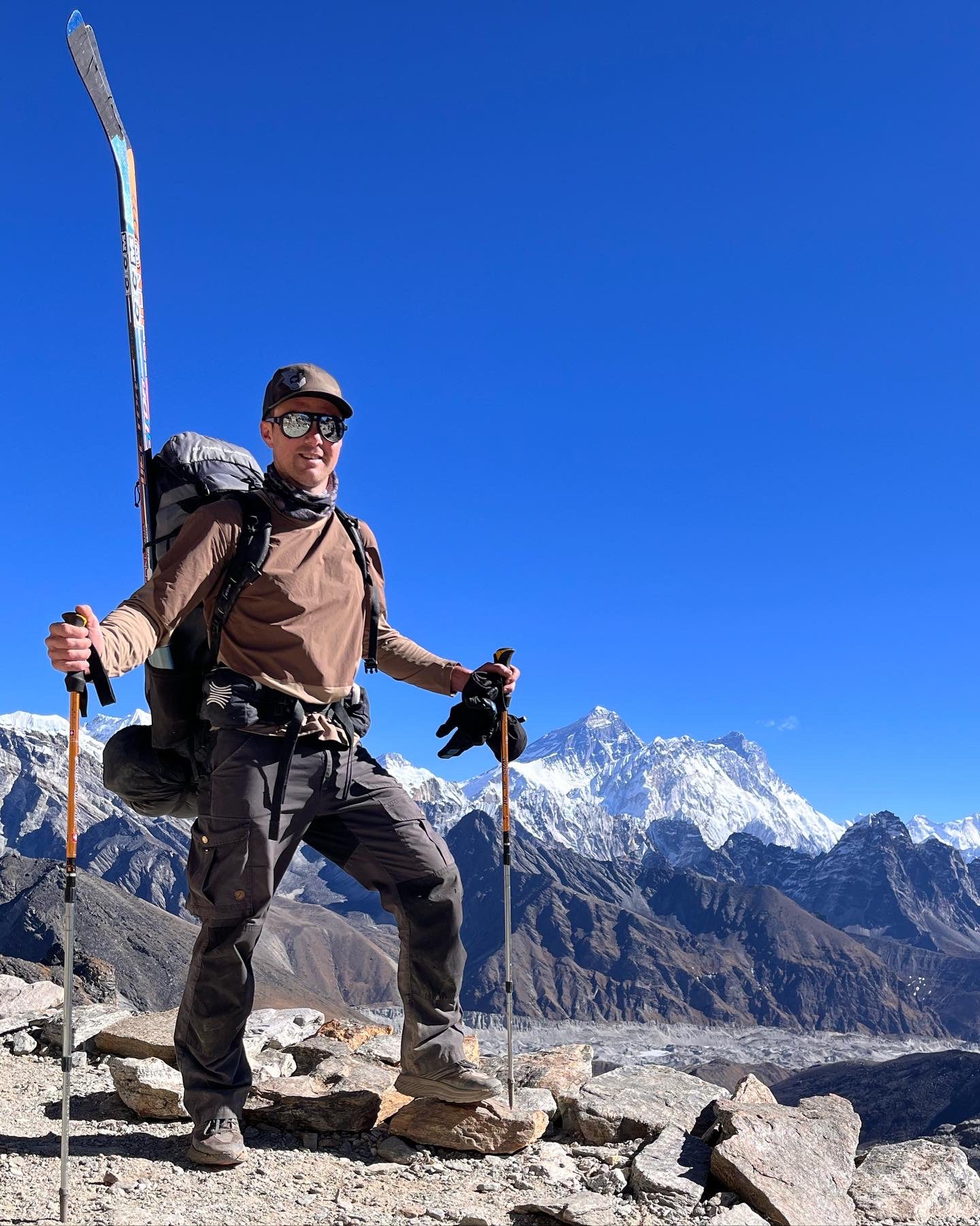 Cory Wallace poses in front of Mt. Everest beforey playing himalayan hockey 