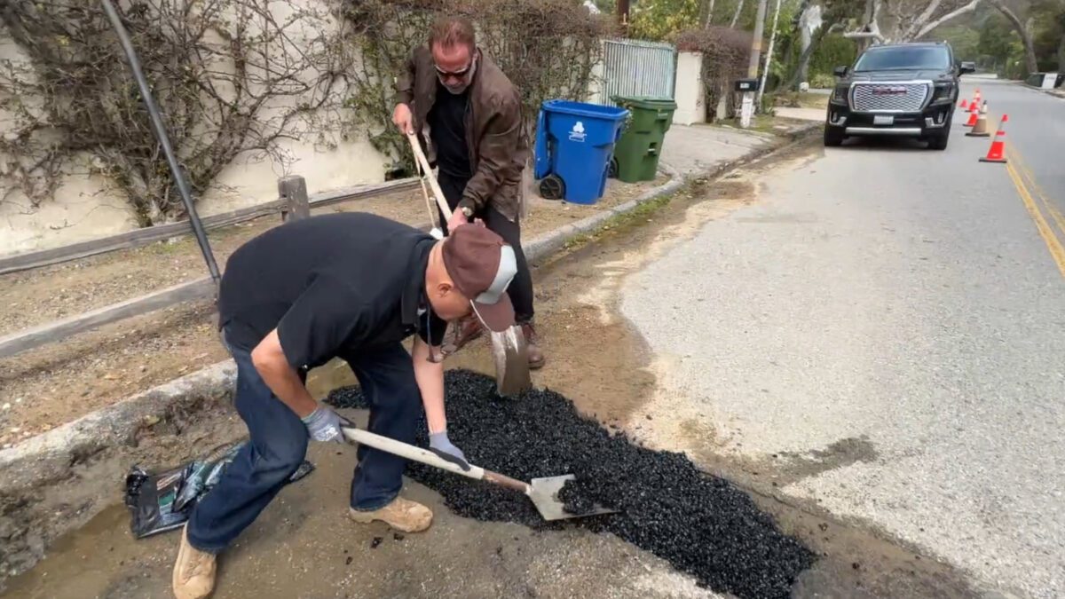 Arnold fixing a pothole