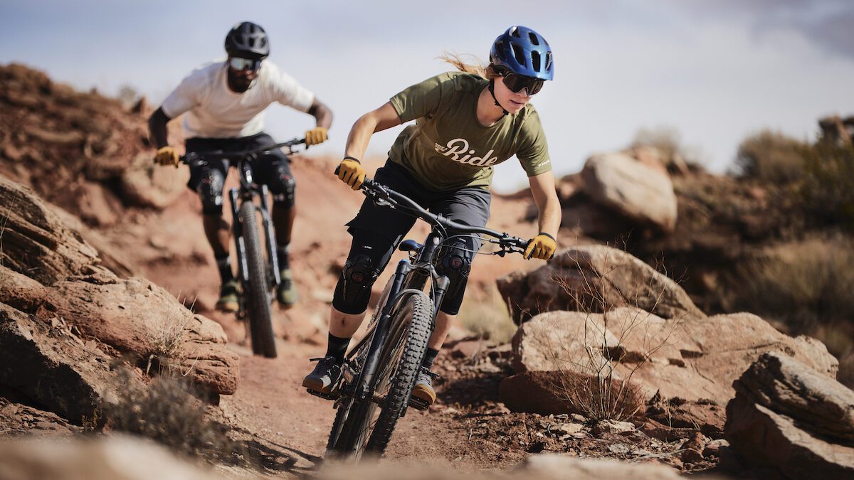 Two riders wear Trek Apparel while riding mountain bikes in Utah