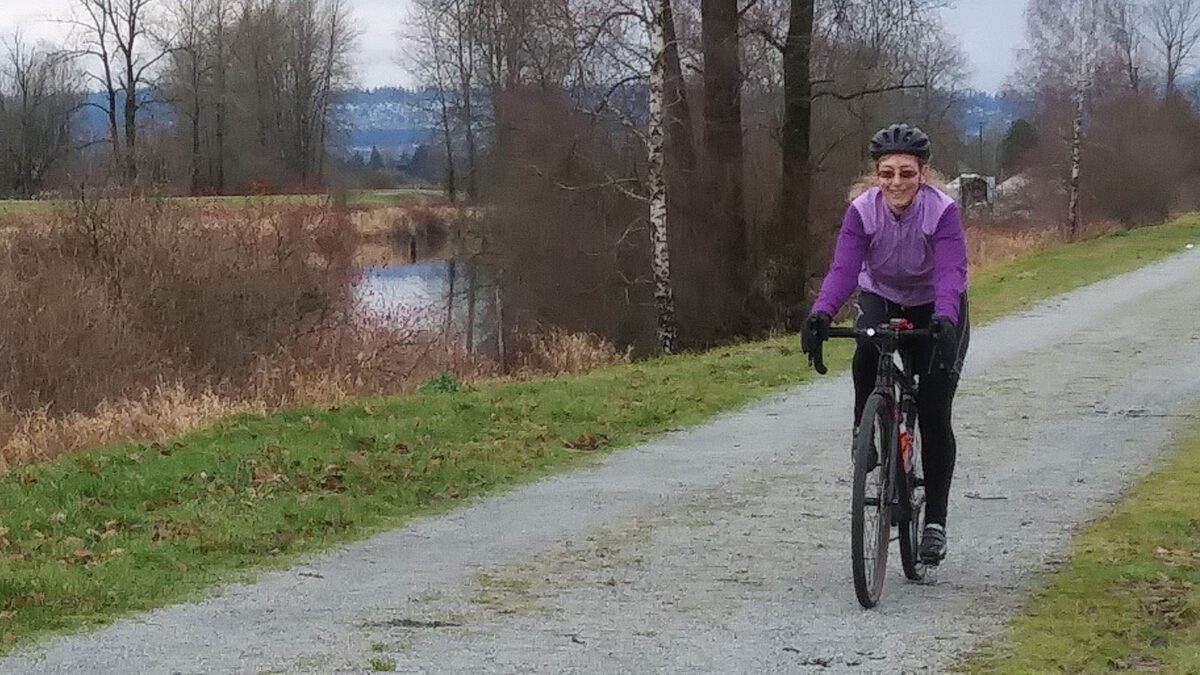 Alex Marais on her bike on a gravel trail.
