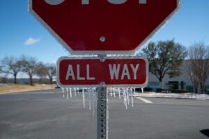 All Way Stop sign with Ice Cycles during Winter Storm 2022