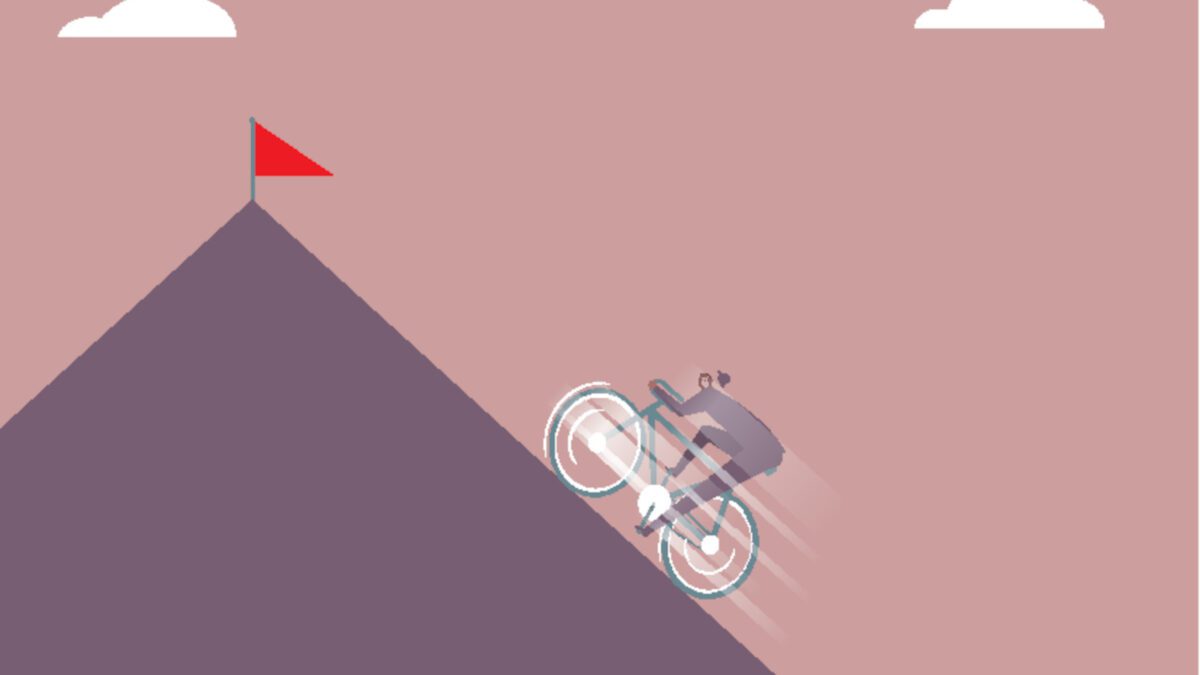 A cyclist rides up a hill