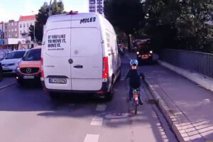 A van comes close to a german kid cycling