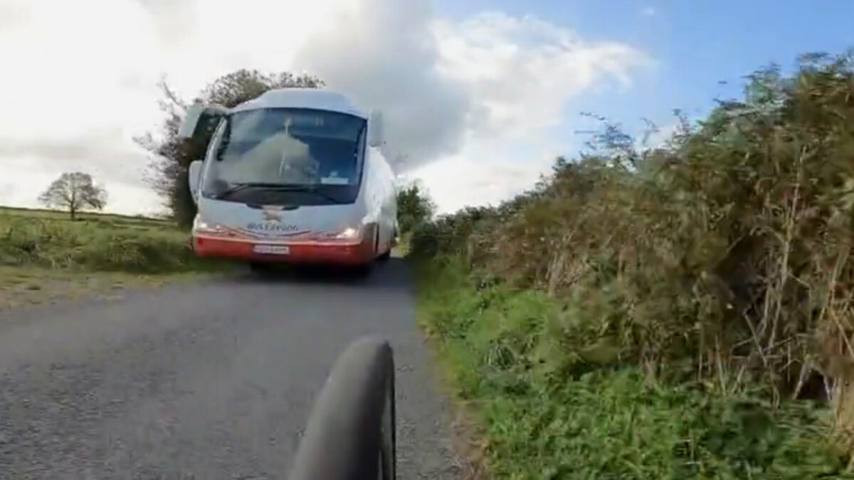 A bus close-passing a cyclist