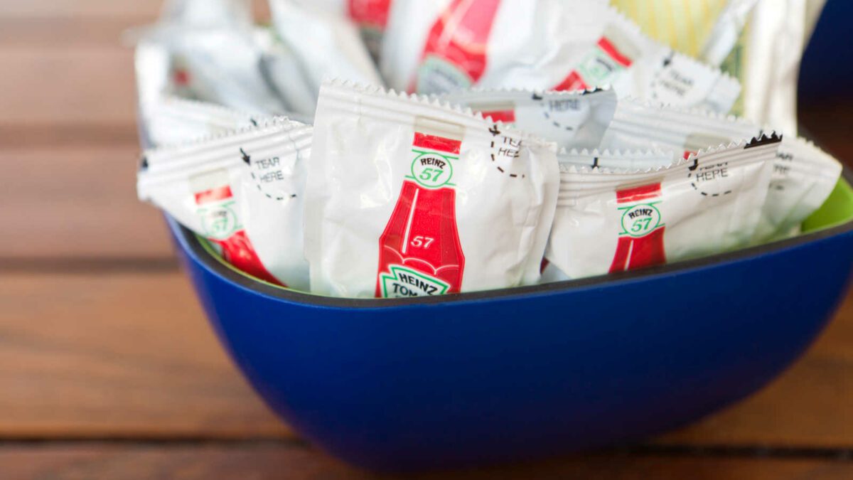 "Nassau, Bahamas - March 28, 2012: Bowl containing condiment packets of Heinz 57 ketchup on restaurant table."