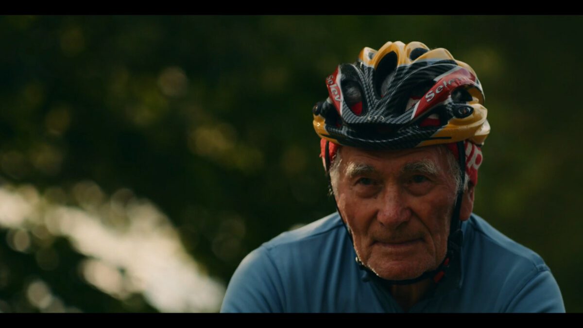 an older man rides his bike