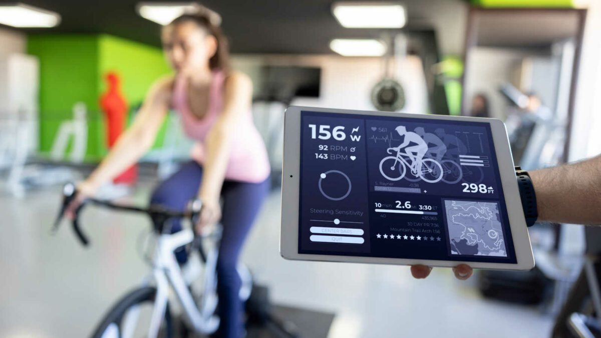 Fit woman taking a stress test while cycling at a health club healthy lifestyle concepts